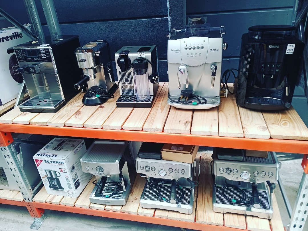 Technician servicing a domestic coffee machine in the workshop